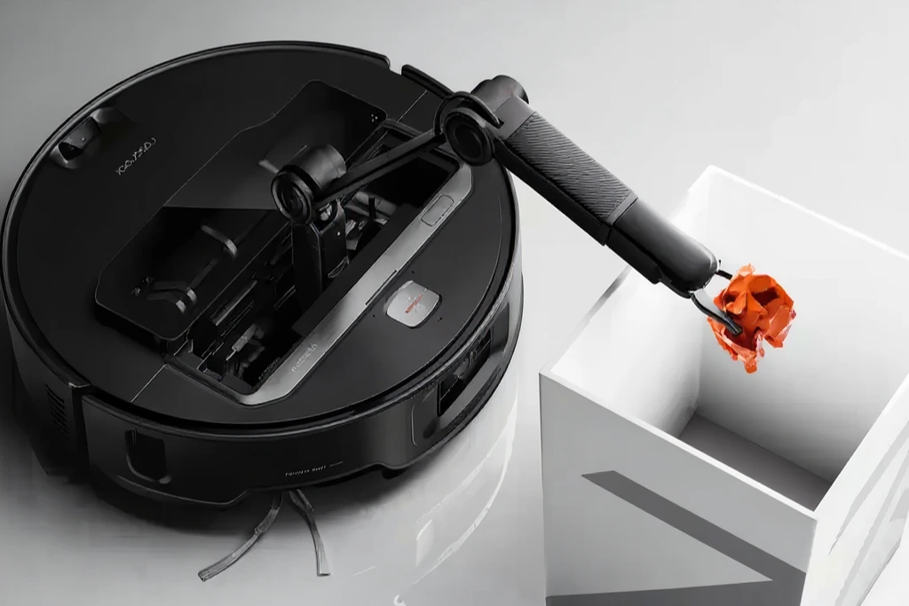  Close-up of the Roborock Saros Z70 tidying floor debris with its integrated mechanical arm.