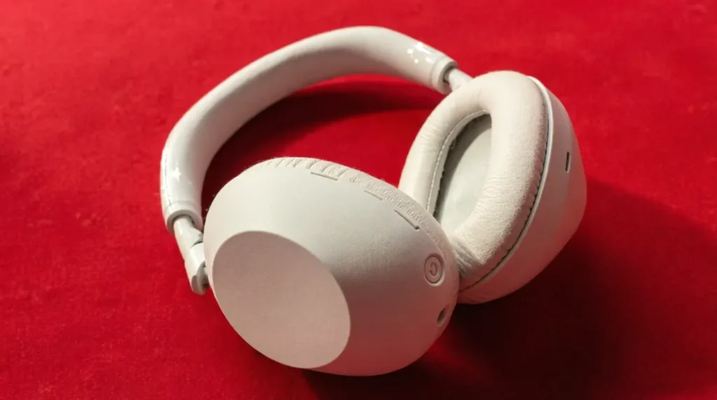Close-up of Sony WH-1000XM4 wireless headphones in silver on a red background. Is the Sony XM4 Still Worth Buying in 2026?