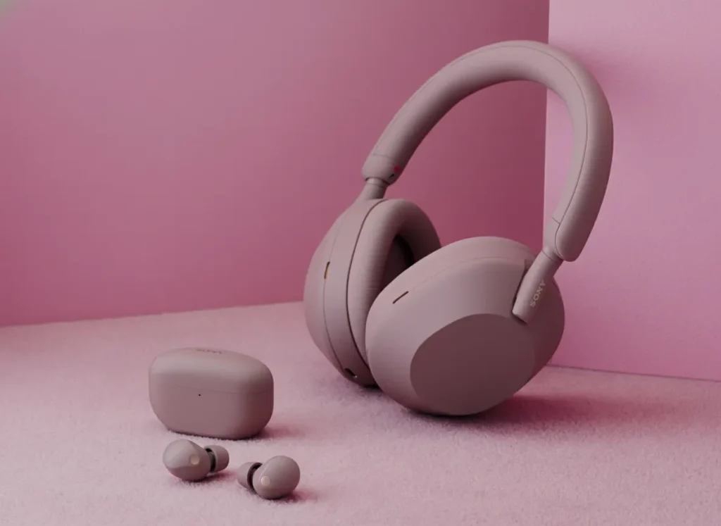 Sony WH-1000XM5 headphones and WF-1000XM5 earbuds in Smoky Pink on a matching background.