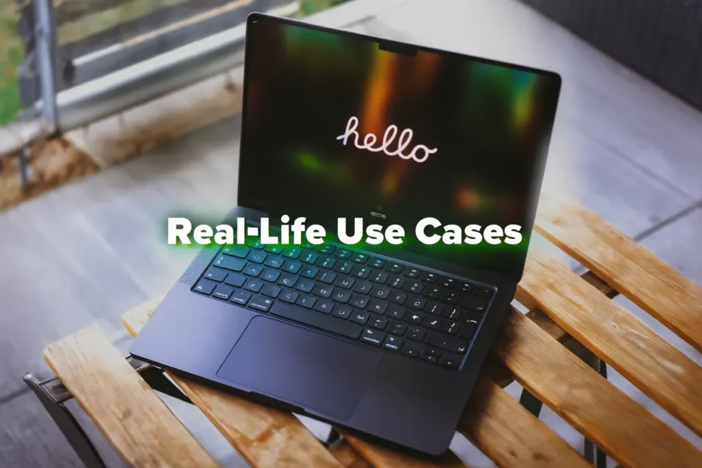 Midnight MacBook Air on a wooden table showing the hello startup screen.